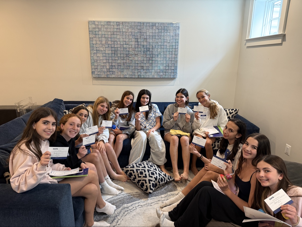 Safe Sitter graduates holding their completion cards