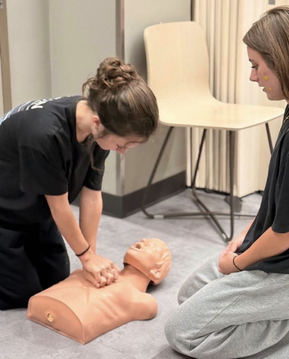 Students practicing hands-on safety skills in class